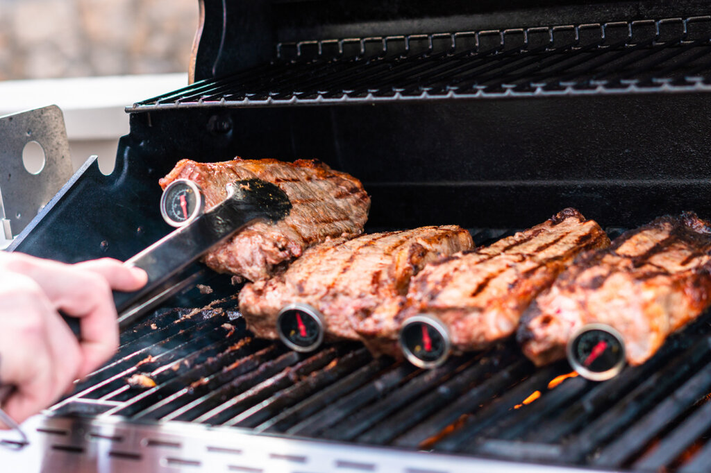 Vier biefstukken met barbecuethermometer